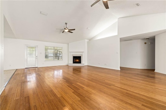 unfurnished living room featuring ceiling fan, light wood-type flooring, and high vaulted ceiling