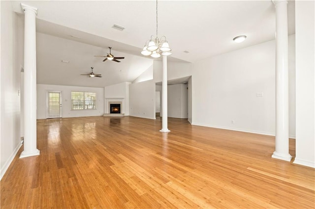 unfurnished living room featuring ceiling fan with notable chandelier, light wood-type flooring, and high vaulted ceiling