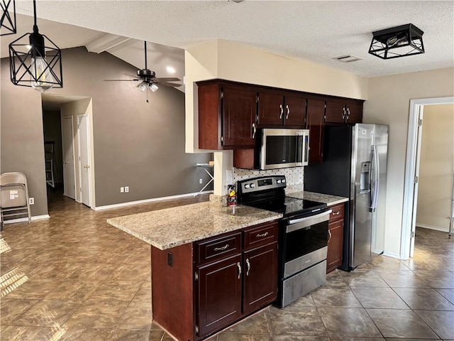 kitchen featuring vaulted ceiling with beams, a textured ceiling, ceiling fan, stainless steel appliances, and pendant lighting