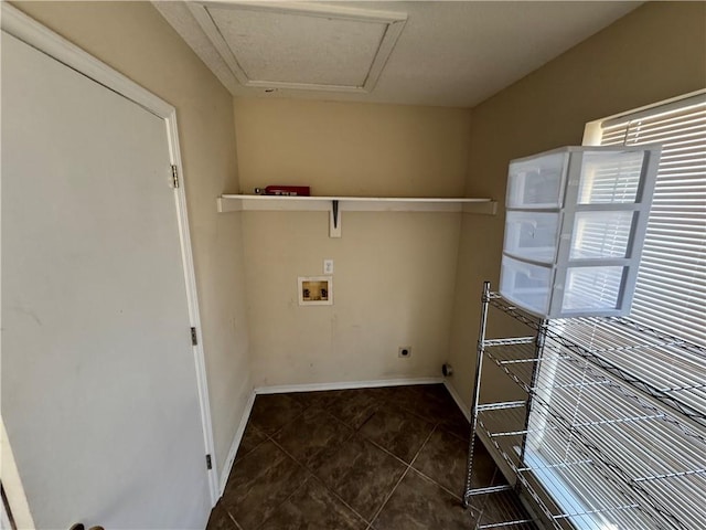 laundry area featuring hookup for a washing machine, electric dryer hookup, and dark tile patterned flooring