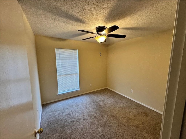 unfurnished room with a textured ceiling, carpet floors, and ceiling fan