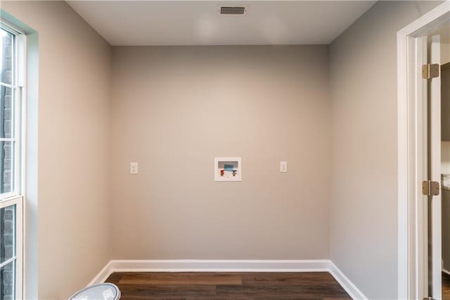 clothes washing area featuring visible vents, baseboards, dark wood finished floors, washer hookup, and laundry area