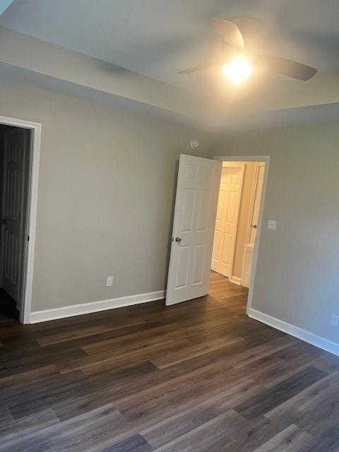 unfurnished room featuring ceiling fan and dark hardwood / wood-style floors