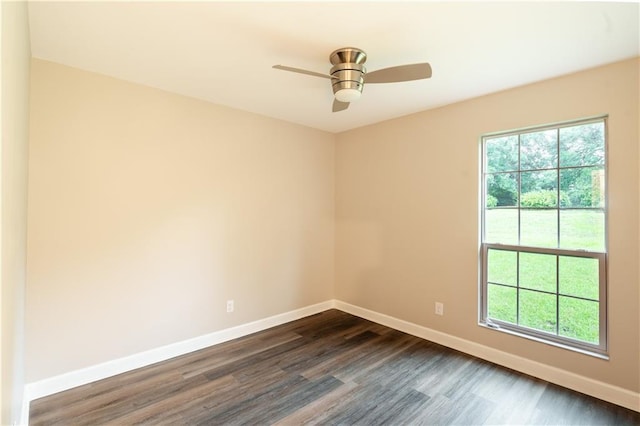 unfurnished room with dark wood-type flooring, a healthy amount of sunlight, and baseboards