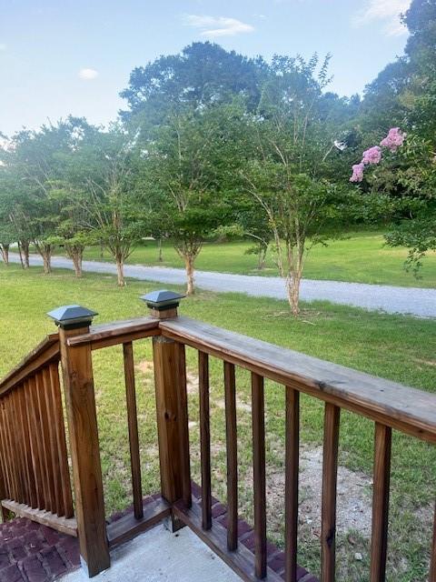 wooden terrace with a yard