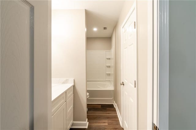 full bath featuring a bath, wood finished floors, visible vents, a shower, and toilet