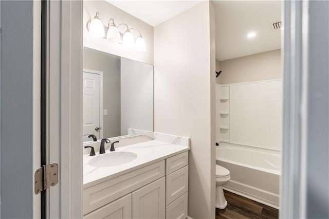 bathroom featuring shower / tub combination, toilet, vanity, and wood finished floors