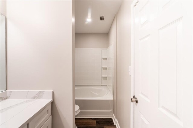 full bathroom featuring vanity, toilet, shower / bath combination, and hardwood / wood-style flooring