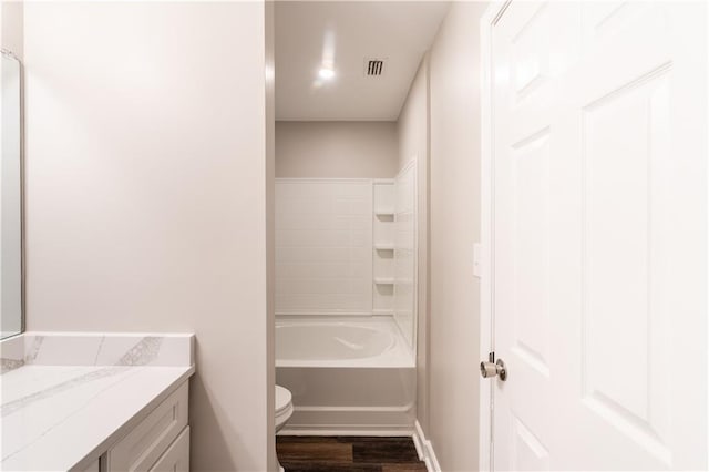 full bathroom featuring visible vents, baseboards, toilet, wood finished floors, and vanity