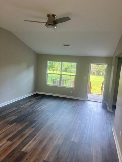 empty room featuring lofted ceiling, a healthy amount of sunlight, and ceiling fan