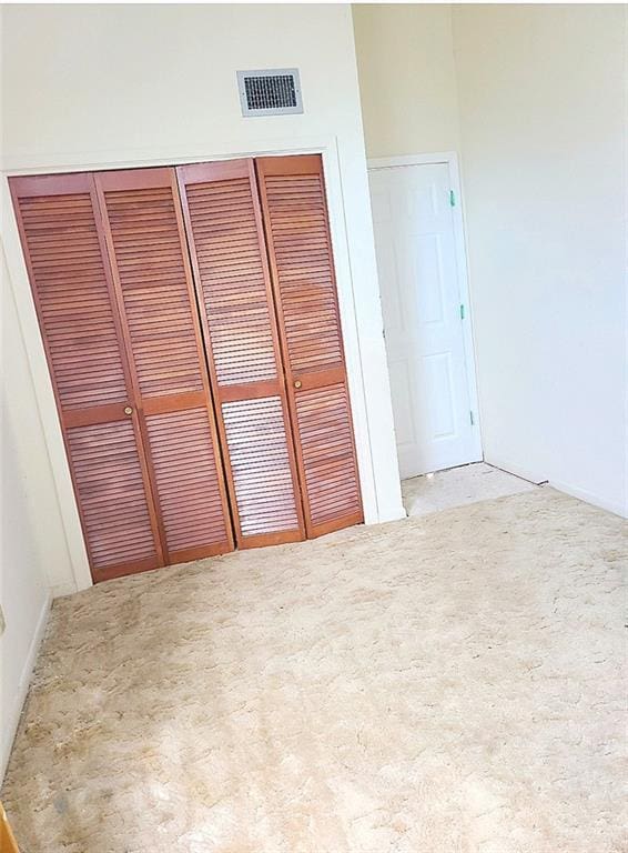 unfurnished bedroom featuring visible vents and a closet