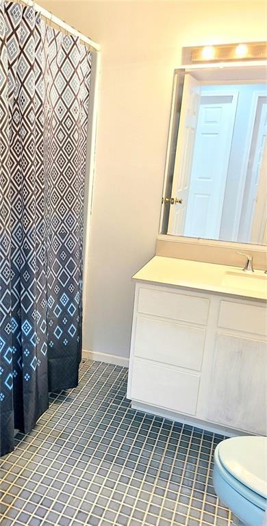 full bath with vanity, toilet, and tile patterned floors