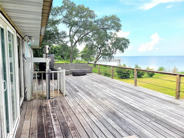 deck with a water view and an outdoor living space