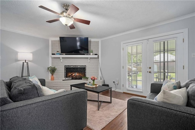 1120 Abilene Dr W, Mobile, AL 36695 - living room featuring ornamental molding, a textured ceiling, wood finished floors, a fireplace, and ceiling fan