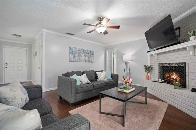 1120 Abilene Dr W, Mobile, AL 36695 - living area with wood finished floors, ceiling fan, a fireplace, crown molding, and a textured ceiling