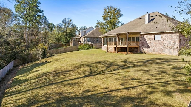 view of yard with a fenced backyard and a wooden deck