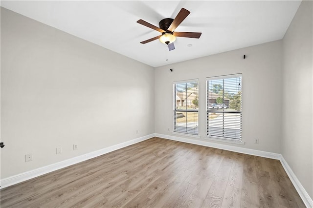 unfurnished room featuring ceiling fan, wood finished floors, and baseboards