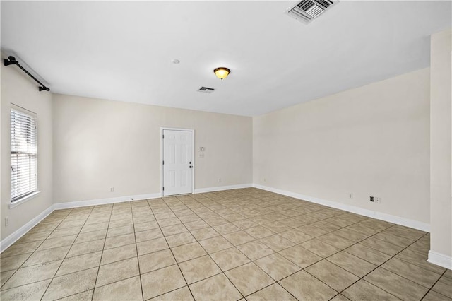 unfurnished room featuring visible vents and baseboards