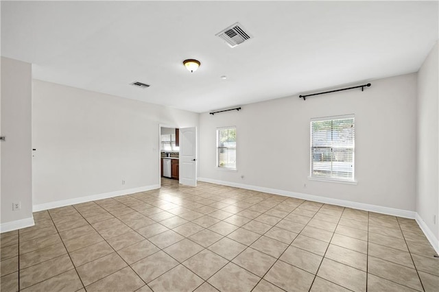 unfurnished room with visible vents and baseboards