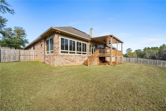 rear view of property with a chimney, brick siding, stairway, and a fenced backyard