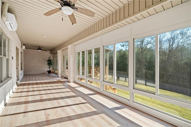 unfurnished sunroom featuring a healthy amount of sunlight and a ceiling fan