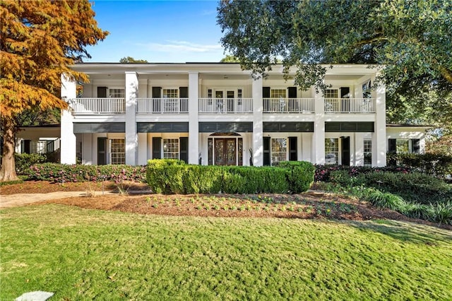 exterior space featuring a balcony and a yard