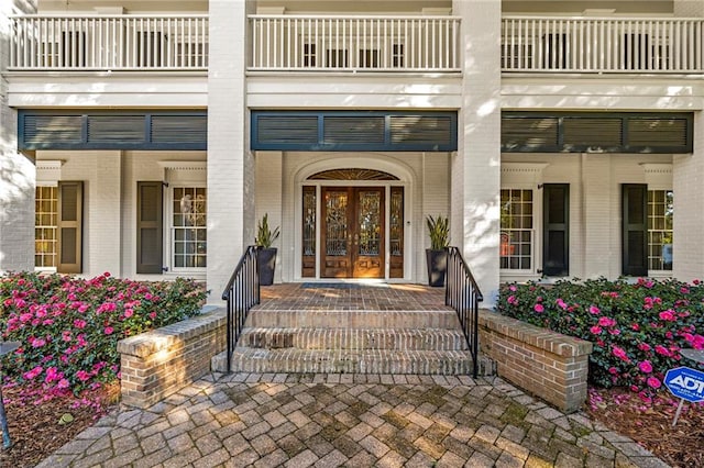 entrance to property with a balcony and french doors