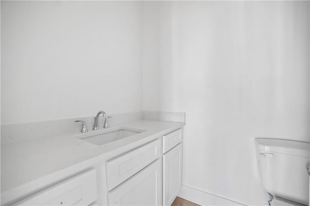 bathroom with toilet and vanity