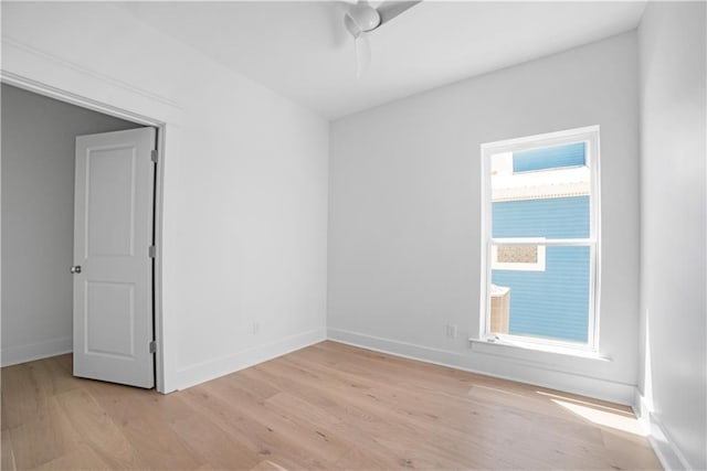 empty room with light wood-style floors and baseboards