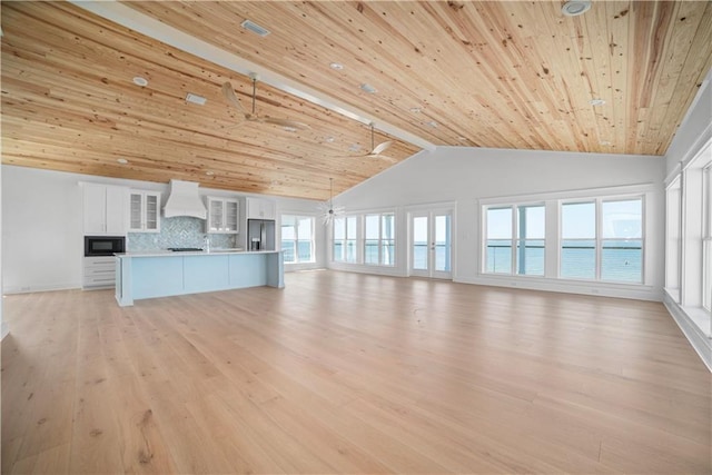 unfurnished living room with wooden ceiling, light wood-style flooring, high vaulted ceiling, and ceiling fan