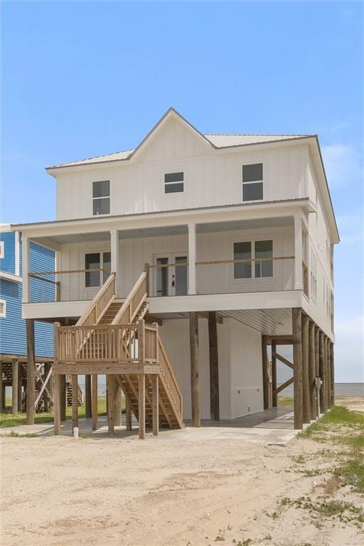 2626 Bridgeview Dr, Dauphin Island, AL 36528 - rear view of property with a carport, driveway, stairway, a porch, and board and batten siding