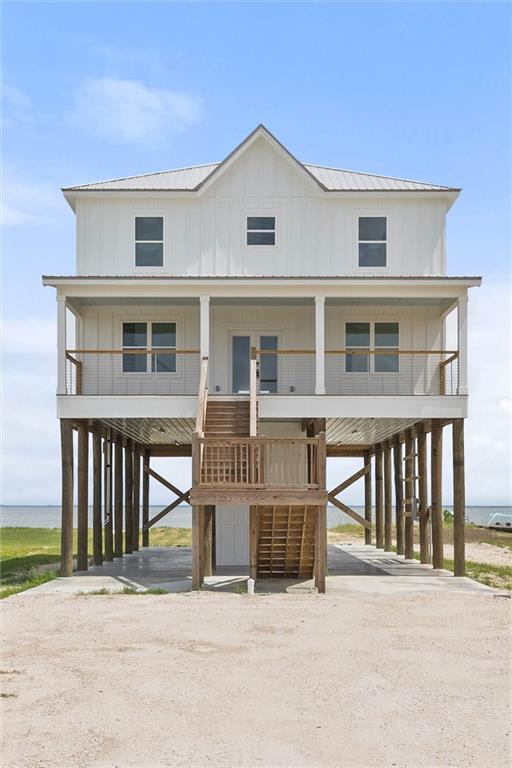 2626 Bridgeview Dr, Dauphin Island, AL 36528 - beach home featuring a carport, dirt driveway, stairway, and a porch