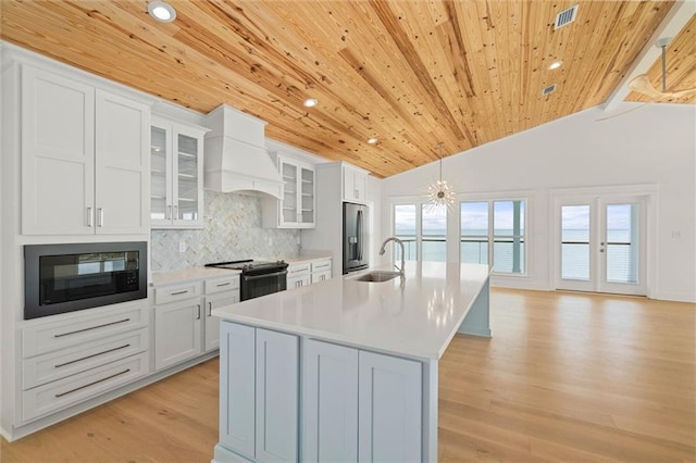2626 Bridgeview Dr, Dauphin Island, AL 36528 - kitchen featuring black microwave, custom exhaust hood, electric range, wood ceiling, and stainless steel refrigerator with ice dispenser