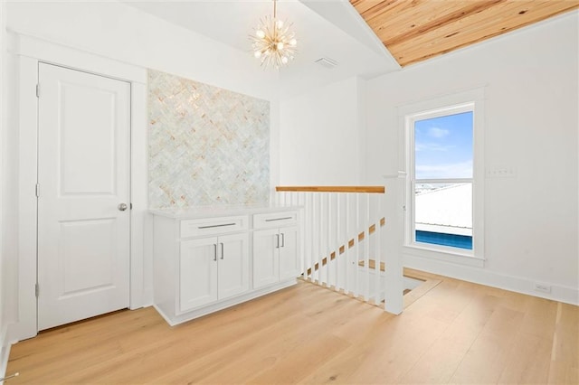 2626 Bridgeview Dr, Dauphin Island, AL 36528 - empty room featuring wood ceiling, light wood-style floors, and a chandelier