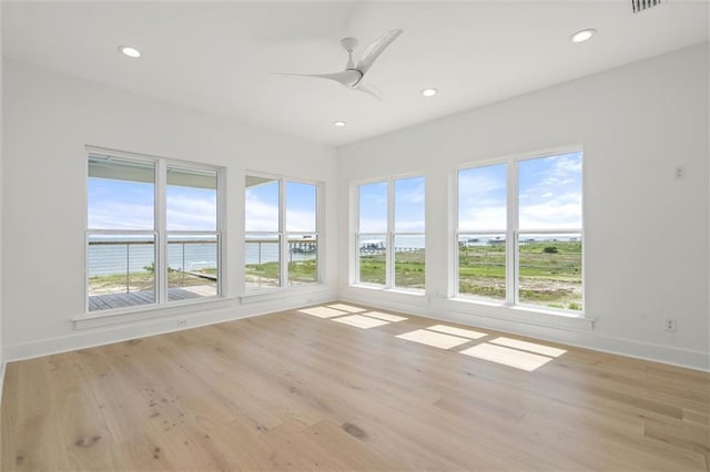 2626 Bridgeview Dr, Dauphin Island, AL 36528 - unfurnished sunroom with a water view, recessed lighting, and wood finished floors
