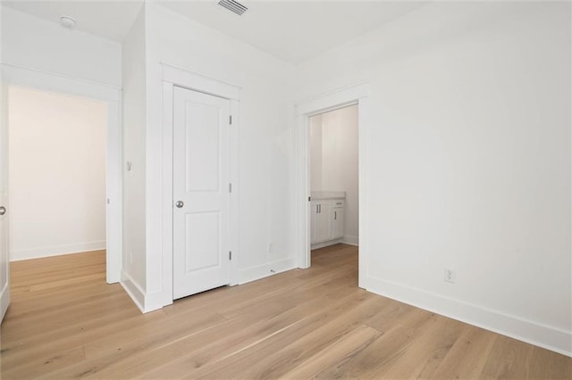 2626 Bridgeview Dr, Dauphin Island, AL 36528 - unfurnished bedroom with light wood-style flooring and a closet