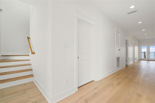 2626 Bridgeview Dr, Dauphin Island, AL 36528 - hall featuring light wood-type flooring, recessed lighting, french doors, and stairs