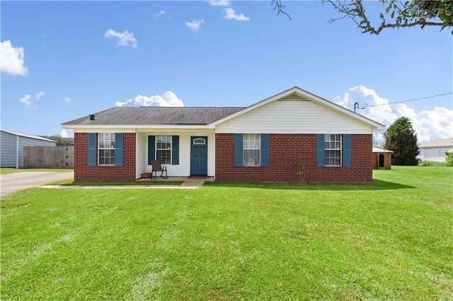 single story home with a porch and a front yard