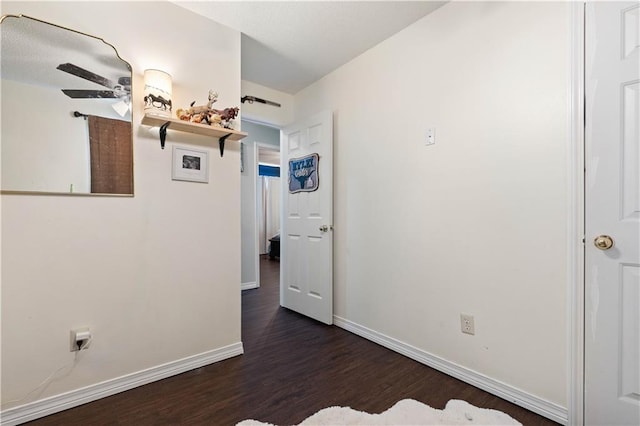 spare room with dark hardwood / wood-style floors and ceiling fan