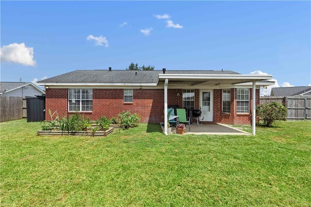 rear view of house with a lawn and a patio area