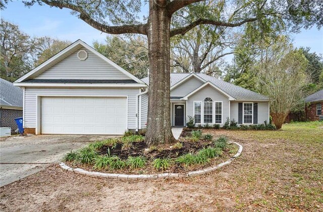 ranch-style home featuring an attached garage and concrete driveway