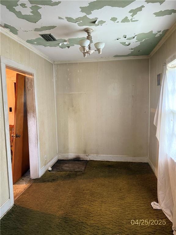 557 Kent St, Mobile, AL 36617 - unfurnished room featuring dark carpet, crown molding, a chandelier, and wood walls