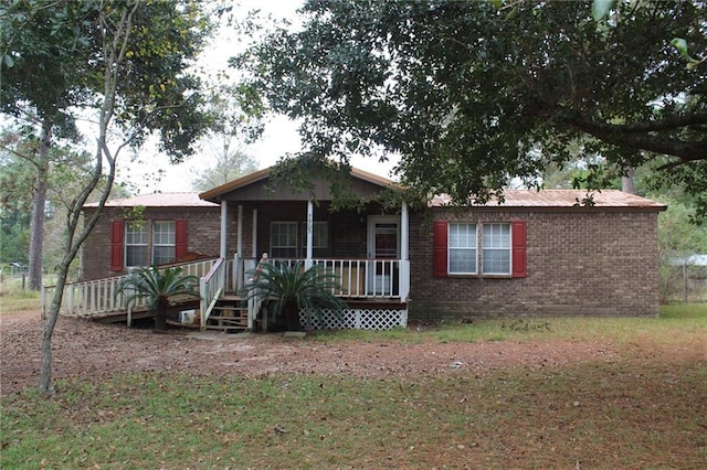 view of front of property with covered porch and a front yard