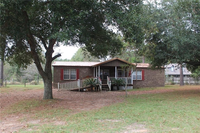 single story home featuring a sunroom and a front lawn