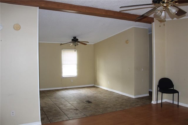 unfurnished room featuring a textured ceiling, ceiling fan, beamed ceiling, and dark hardwood / wood-style floors