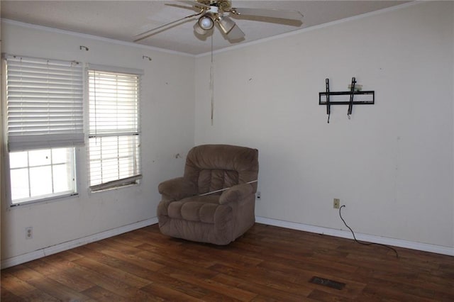 sitting room with dark hardwood / wood-style floors, ceiling fan, and ornamental molding