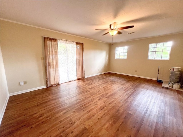 empty room featuring wood-type flooring, ornamental molding, and ceiling fan