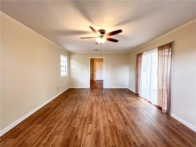 empty room featuring ornamental molding, ceiling fan, and hardwood / wood-style floors