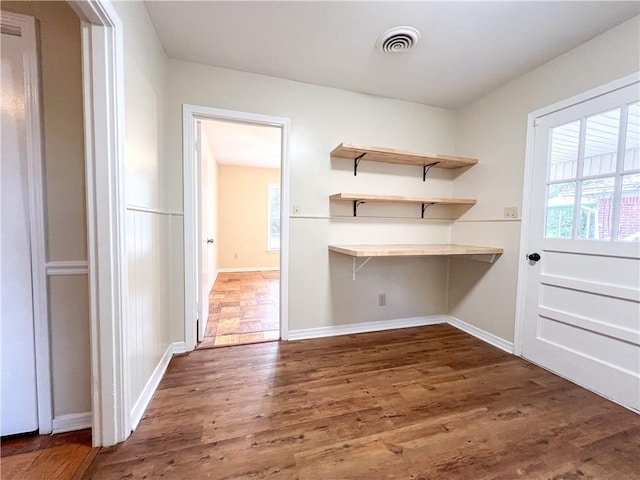 clothes washing area with dark hardwood / wood-style flooring