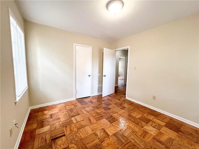 unfurnished bedroom featuring light parquet floors